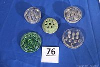 Group of five flower frogs on table