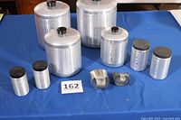 Group shot of 4 canisters, 2 shakers, 2 scoops