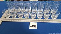 All sixteen Anchor Hocking polka dot glasses lined up with ruler for scale