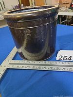 Side view showing brown glaze, incised 2, overall form, measuring scale