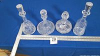 All four decanters lined up beside ruler