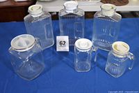 Group shot of all six glass refrigerator bottles showing relative sizes and lids