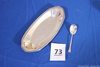 Bread plate and spoon on blue background with lot number