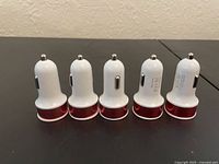Five identical car chargers upright