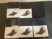 Six boxed Logitech CREATE iPad Pro cases arranged in two rows