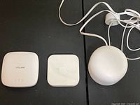 All three devices side by side: YoLink hub, Apple square router, Google round router