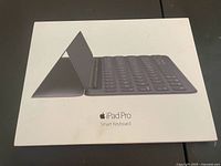 Front of retail box showing Apple iPad Pro Smart Keyboard image and branding.