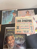Several LPs spread out showing covers (Sinatra, Armstrong, Vaughan?, Nat King Cole)
