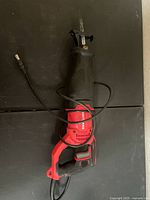 Craftsman red and black reciprocating saw with cord wrapped around body