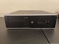 Front view showing HP logo, optical DVD drive, six USB ports, audio jacks