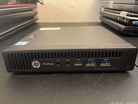 Front view showing HP logo, ProDesk branding, audio jacks, USB-C and USB 3.0 ports
