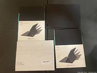 Two boxed Logitech Create cases, one boxed Surface Pro Type Cover, one loose black tablet cover