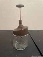 Full view of mixer showing glass jar and plunger lid