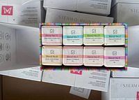 Multiple sealed white SteamO Riginals boxes plus one opened showing assorted cube steamers