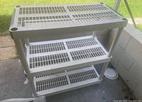 Full view of white plastic four-tier shelf