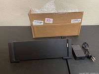 Docking station, power adapter and cardboard box