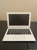 Front view of white Acer laptop, screen open