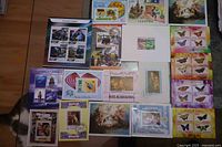 Group shot showing all 18 souvenir stamp sheets laid out