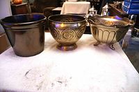 Three planters side by side showing overall forms and finishes