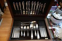 Open Birks chest showing two tiers of Keltum flatware neatly arranged
