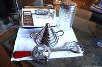 Group shot of GE mixer, stainless sugar bowl, glass cheese shaker, rotary beater