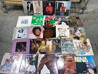 Overview of all 24 album covers laid out on table