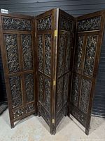 Full view of four-panel carved wooden screen