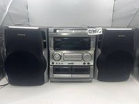 Front view showing main unit and both speakers