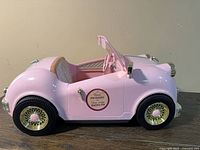 Full left side view of pink American Girl convertible