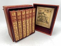 Set of six miniature books in red slipcase, slipcase open showing ex-libris plate