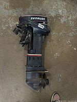 Full view of Evinrude outboard motor lying on floor
