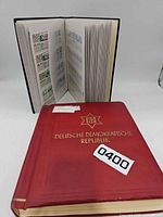 Front cover of Deutsche Demokratische Republik album, additional album open showing stamp pages