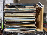 Entire stack of LPs in wooden crate on shelving