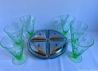 six green uranium tumblers and metal tray with four lidded dishes