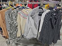 Overall rack showing six garments on hangers