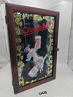 Front view showing Olympia Beer painted mirrored door