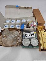 Overview showing porcelain knobs, glass knobs, packaged knobs, brass hinges