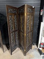 Full view of folded three-panel carved wood screen