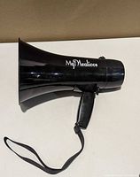 Left side view showing logo, handle and strap