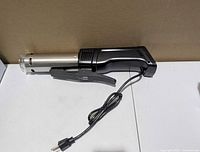 Side view showing full circulator, stainless sleeve, clamp, and power cord