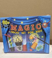 Front of sealed Heyzeibo Magic Tricks Set box showing 60+ tricks claim and illustrated props