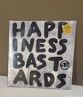 Front of sealed vinyl with album title and hype sticker