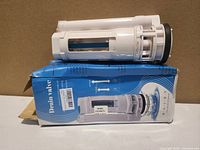 Toilet drain valve assembly resting on its retail box