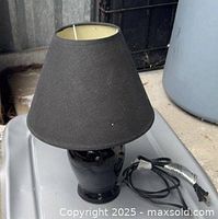 Entire lamp showing ceramic base, fabric shade, and power cord