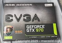 Front view of EVGA GeForce GTX 970 retail box showing model, memory capacity, SSC and ACX 2.0+ designations