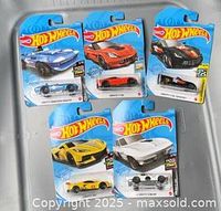 Group shot of five carded Hot Wheels cars showing fronts of blister packs