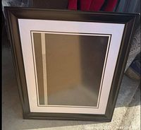 Front view of dark brown wood picture frame with white double mat