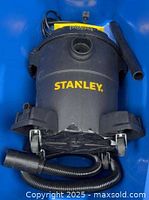 Overall view of Stanley wet/dry vacuum, hose and wand visible