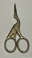 Full view of stork-shaped sewing scissors