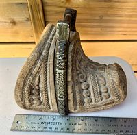 profile view showing carved details and ruler for scale